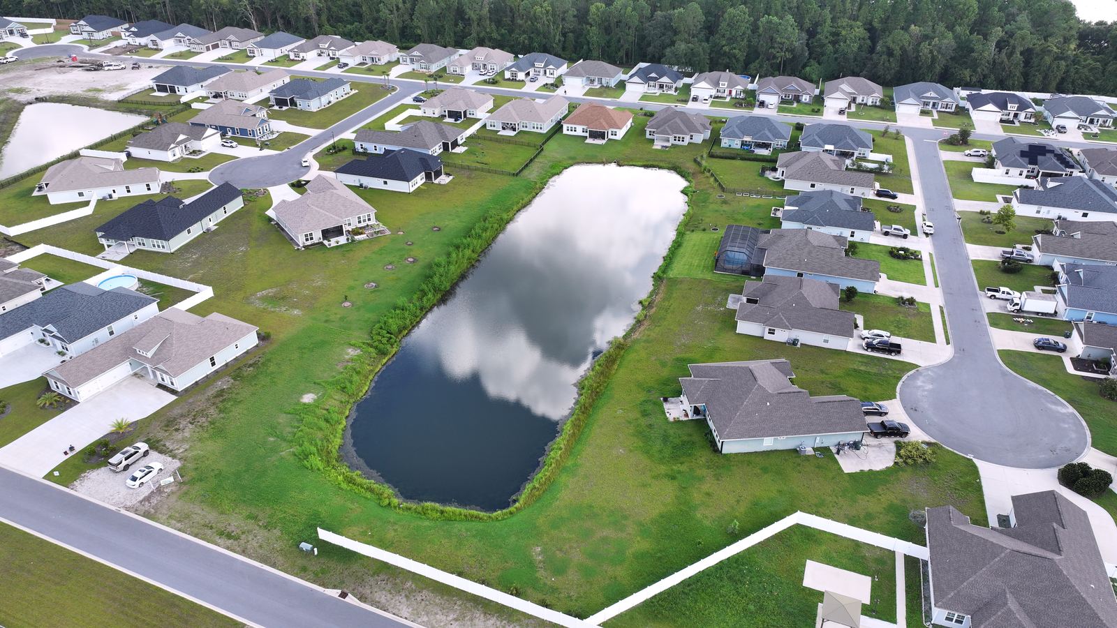Aerial of a new construction community and pond