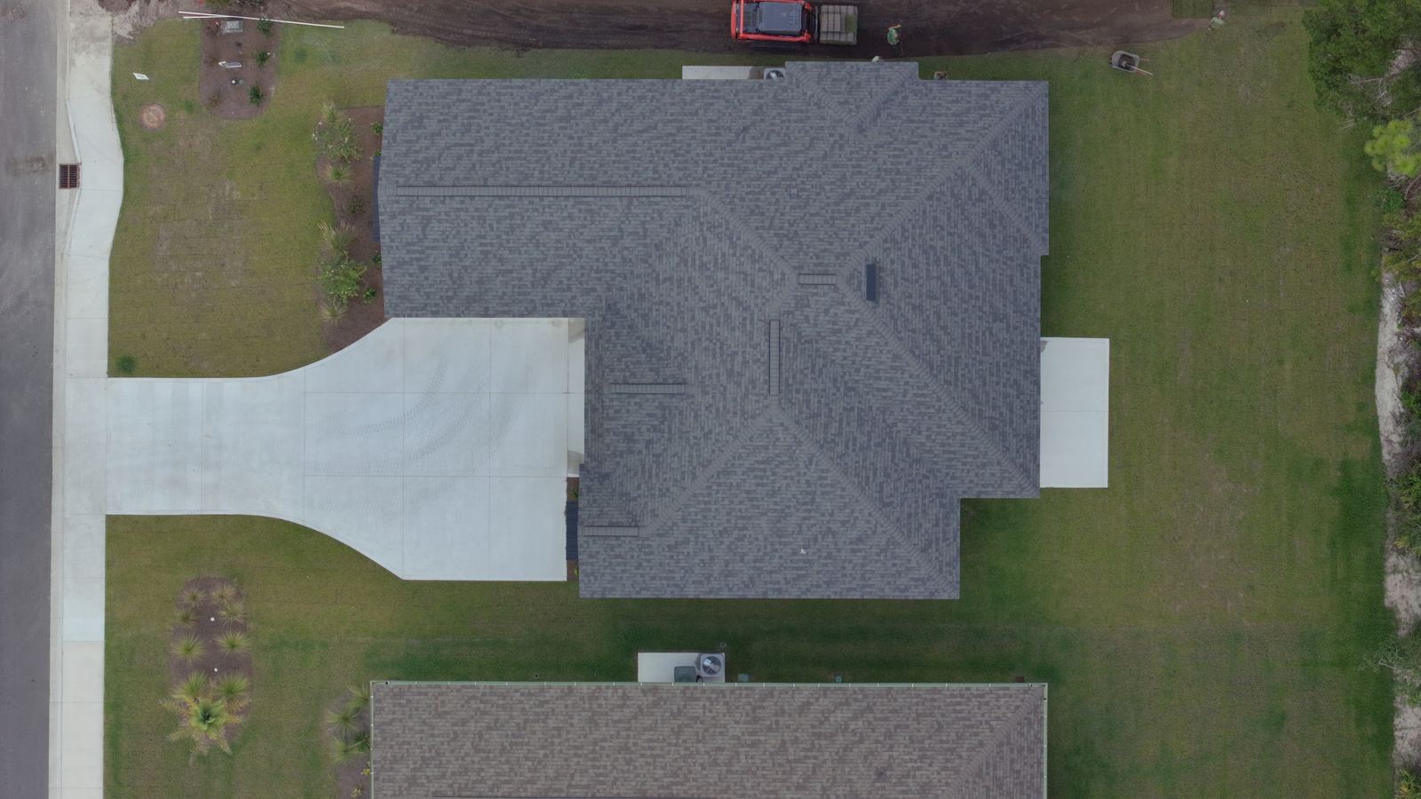 Top down aerial of a house, driveway and lot