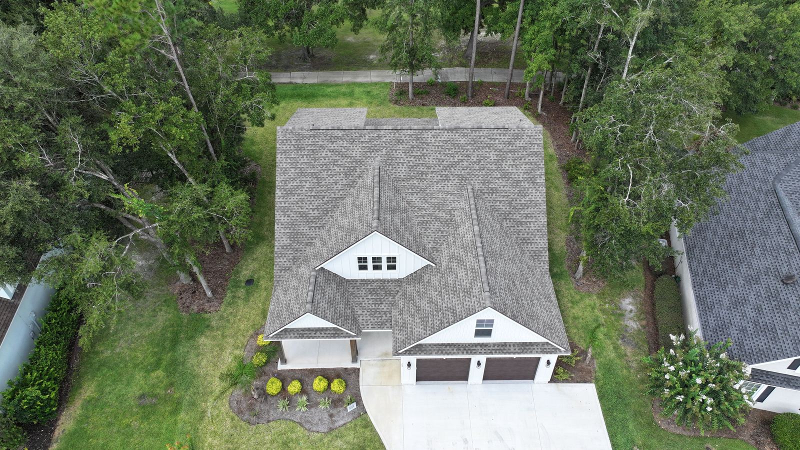 Top down view of a completed roof and driveway